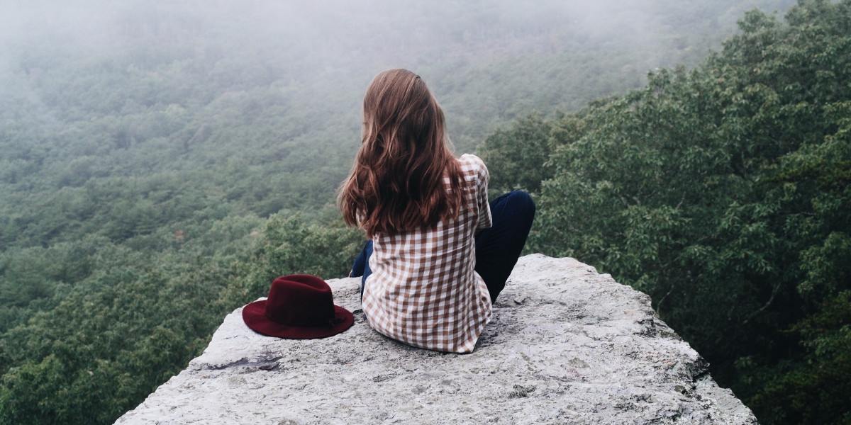 Woman looking from a rock